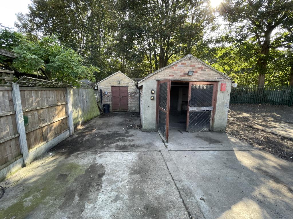 Lot: 53 - GATED STORAGE AND WORKSHOP YARD WITH POTENTIAL - View of garages from gates